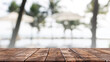 Empty wood table top and blurred summer beach bar in tropical resort banner background - can used for display or montage your products.
