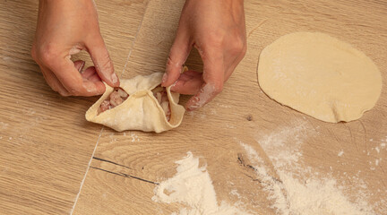 Poster - Cooking dough with meat on the table.