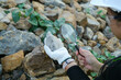 © Pornpimon - Female geologist using a magnifying glass examines nature, analyzing rocks or pebbles. Researchers collect samples of biological materials. Environmental and ecology research.
