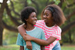 © amorn - Happy two African American boy and girl playing and hugging together outdoor