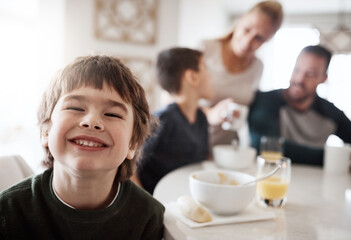 Wall Mural - Happy, breakfast and portrait of boy with family for at kitchen table for food, child development and bonding. Quality time, smile and happiness with son at home for diet, morning and nutrition