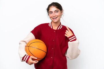 Wall Mural - Young basketball player woman isolated on white background giving a thumbs up gesture