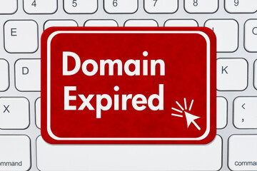 Domain Expired message on a sign on a computer keyboard