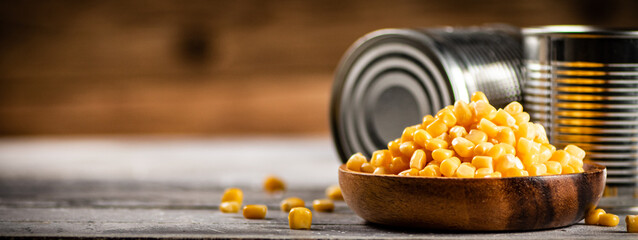 Sticker - A plate of canned corn on the table.