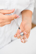 © fesenko - Close-up view of female caucasian hands pouring liquid medicine from a bottle into a syringe