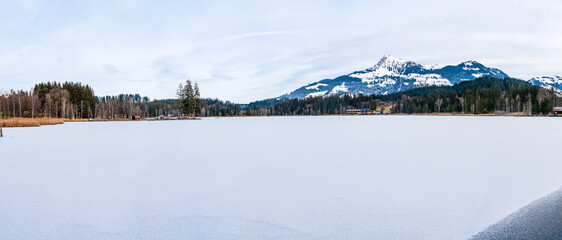 Wall Mural - Schwarzsee lake in Kitzbuhel covered with ice and snow. Winter in Austria