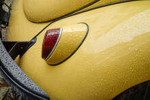 Headlight And Bumper Of Old Beige Beetle Car, Wet From Raindrops
