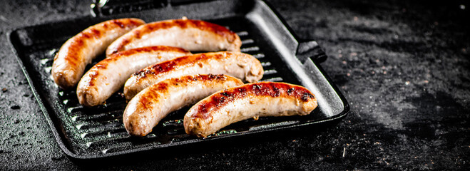 Poster - Grilled sausages in a frying pan. 