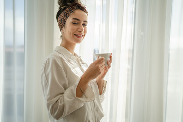 Wall Mural - One woman have a cup of coffee at the window at home morning or day