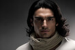 © Fantasy22 - Close-up portrait of a handsome young hispanic / latino man with long hair on a dark background with copy space - not based on a real person, Generative AI