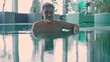 © nyul - Wellness spa - older white man in his 50s relaxing in wellness resort swimming in pool. Leisure and lifestyle, real authentic moment. Happy mid adult, middle aged guy smiling.