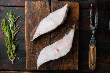 Wall Mural - Raw fresh halibut fish steak, with ingredients and rosemary herbs, on old dark  wooden table background, top view flat lay