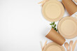 © Jenifoto - Eco friendly disposable dishware for takeout. Side border on a white background. Biodegradable, composable alternative to plastic. Top down view with copy space.