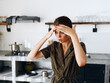 © SHOTPRIME STUDIO - Portrait of a sad tired woman with a sore head in the kitchen, domestic problems, unstable emotional state, onion tears