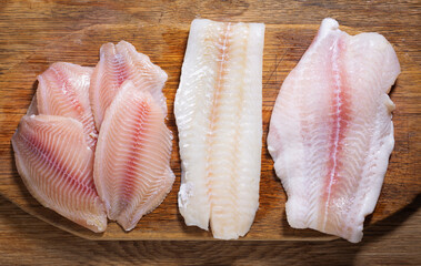 Poster - fish fillet of cod, tilapia and pangasius, top view