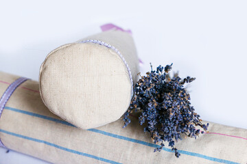 two therapeutic rollers with healing herbs for the treatment of the back and spine with dry lavender and a tablet for the inscription