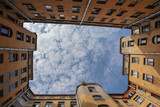Fototapeta Niebo - piece of the blue sky with clouds in iconic famous yard-well in Saint Petersburg, Russia