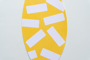 Sticker - yellow paper shape with adhesive white paper stickers or labels