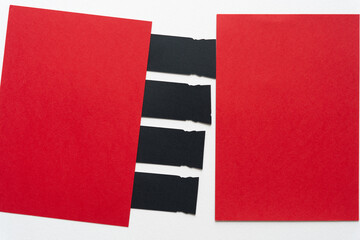 Canvas Print - two red cards and a series of black paper tabs on blank white background