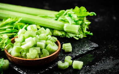 Sticker - Pieces of fresh celery in a wooden plate. 