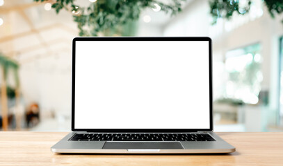 Laptop blank screen on wood table with blurred coffee shop cafe interior background and lighting bokeh, mockup, template for your text, Clipping paths included for background and device screen