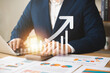 © Thapana_Studio - Businessman analyzing company growth, future business growth arrow graph, development to achieve goals, business outlook, financial data for long term investment.