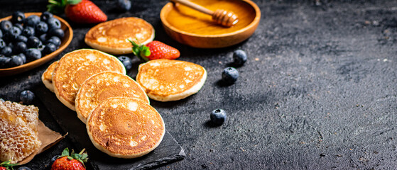 Poster - Pancakes on a stone board with fresh berries. 