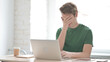 © stockbakers - Young Man Reacting to Loss While Working in Office