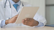 © stockbakers - African Doctor using Tablet for Work