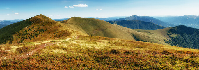 Wall Mural - Amazing panoramic mountains valleys landscape in summer. View of light and afternoon shadow over scenic  hills, clear blue sky.