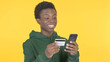 © stockbakers - Online Shopping by Young African Man on Yellow Background