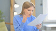 © stockbakers - Upset Woman Feeling Embarrassed while Reading Contract