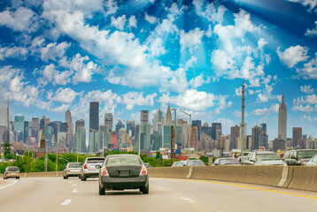 Poster - Major road to New York City at sunset. Car traffic at dusk