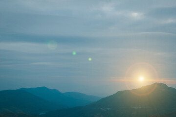 Wall Mural - Natural fog and mountains sunlight background blurring, misty waves warm colors and bright sun light. Sky sunny color orange light patterns evening on clouds blur.