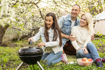 Wall Mural - Happy family having barbecue with modern grill outdoors