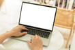 © panitan - computer screen blank mockup.hand woman work using laptop with white background for advertising,contact business search information on desk at coffee shop.marketing and creative design