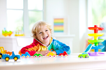 Wall Mural - Boy playing toy cars. Kid with toys. Child and car