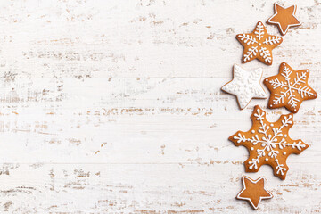 Wall Mural - white background with homemade gingerbread snowflakes icing cookies