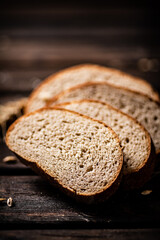 Poster - Slices of sliced bread on a table with a spike. 