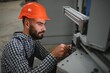 © Serhii - Portrait of industrial engineer. Factory worker with hard hat standing in factory.