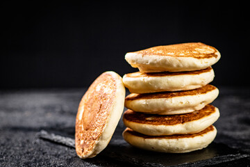 Canvas Print - Ready made homemade pancakes on a stone board. 