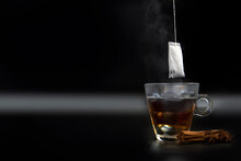Glass Of Hot Tea With Tea Bag Hanging Black Background Copy Space,