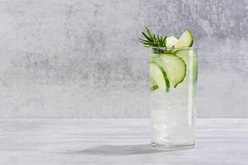 Wall Mural - Cold fresh cucumber water sassi with sprig of rosemary