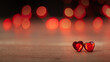 Hintergrundf ür Valentinstag, Verlobung: zwei rote Herzen vor dunklem Bokeh-Hintergrund mit Platz für Text 