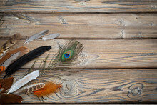 Color Feathers On Old Wooden Background