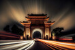 Car tracks formed by long exposure at night in front of ancient Chinese buildings.