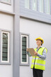 © KMPZZZ - Building inspection, contractor asian young man, male inspecting home, reconstructed construction, renovation or check defect, before finish handing it over to client. Engineering worker, copy space.