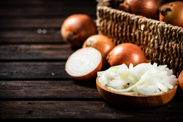 Poster - Pieces of onion in a plate and whole onions in a box. 