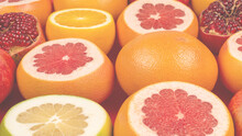 Grapefruit, Orange, Pomegranate, Citrus Sweetie On Red Background.