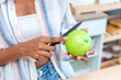 © kanpisut - Woman holding fruit in kitchen room. woman on a diet, a woman vegetarian prepares a eat fruit